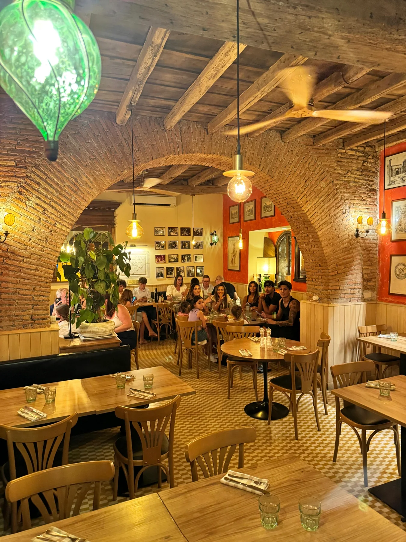 Dining room with large brick arches and wooden tables