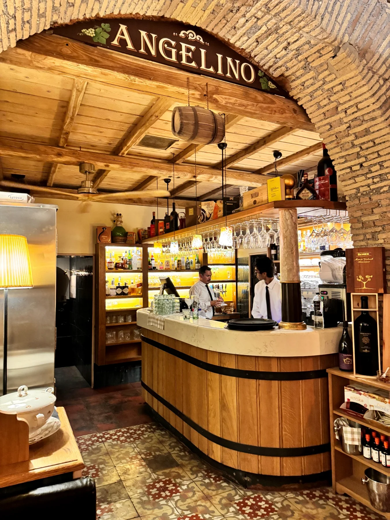 Wooden bar beneath a historic arch